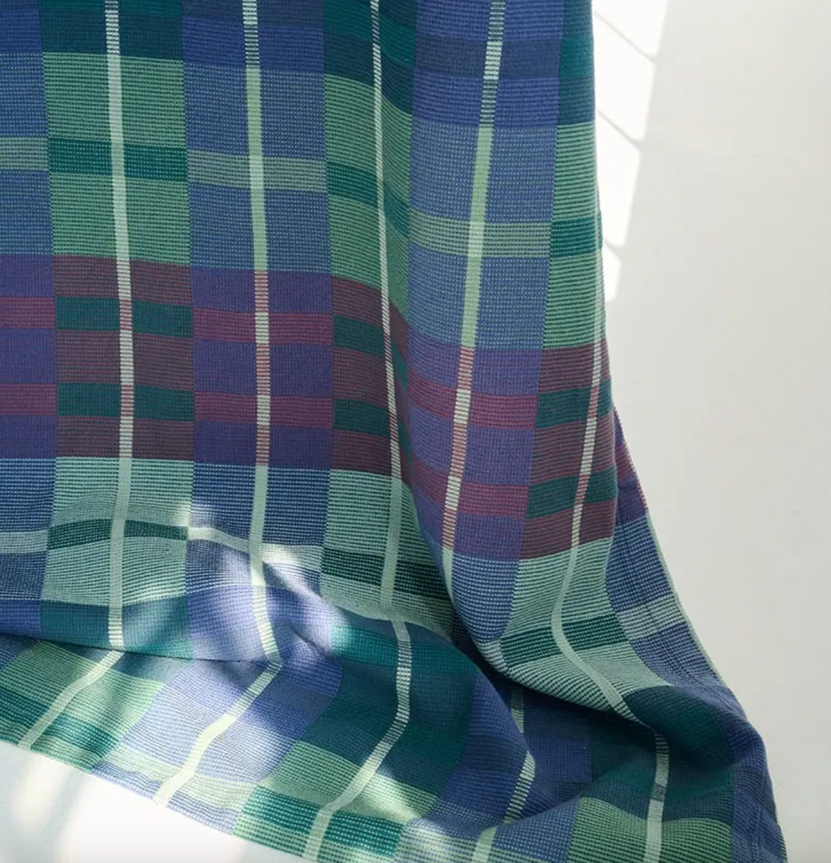 Plaid fabric with blue and green colors on a white background