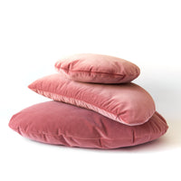 Stack of pink pillows on a white background