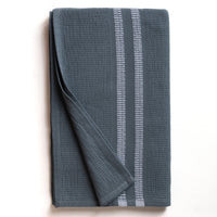 Folded blue bath towel with white stripes