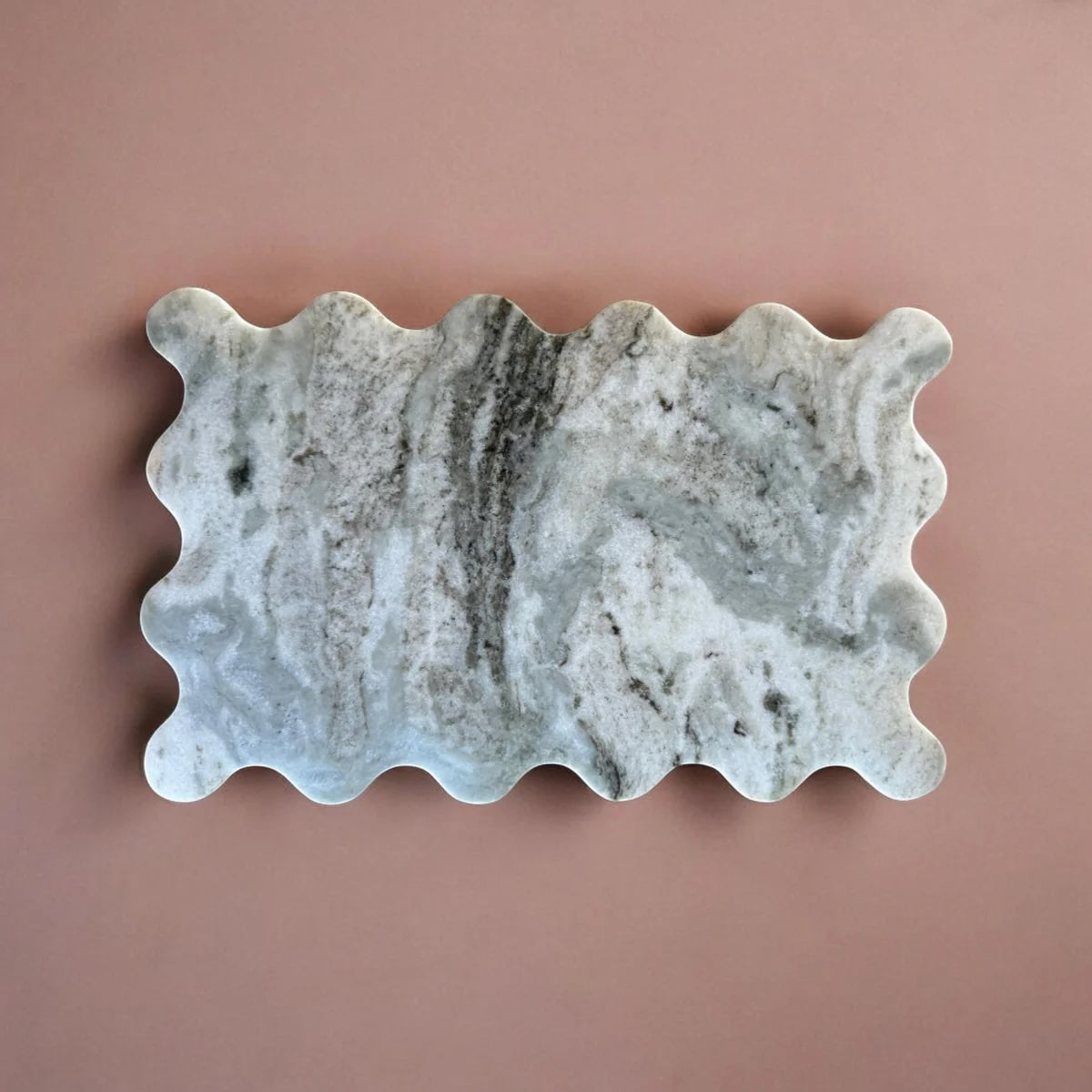 Decorative stone with wavy edges on a pink background