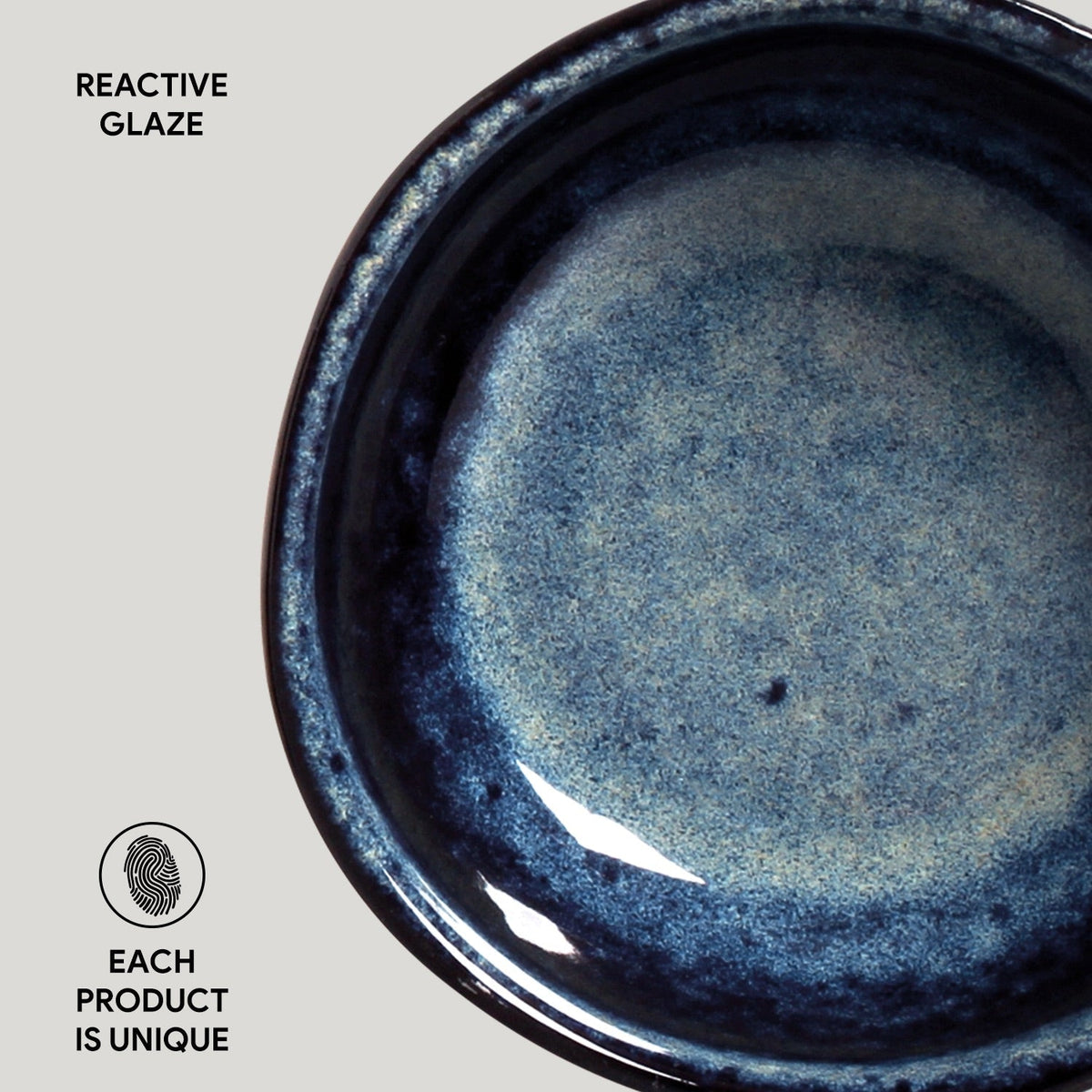 Close-up of a blue ceramic product with reactive glaze on a gray background