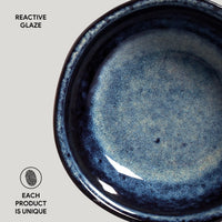 Close-up of a blue ceramic product with reactive glaze on a gray background