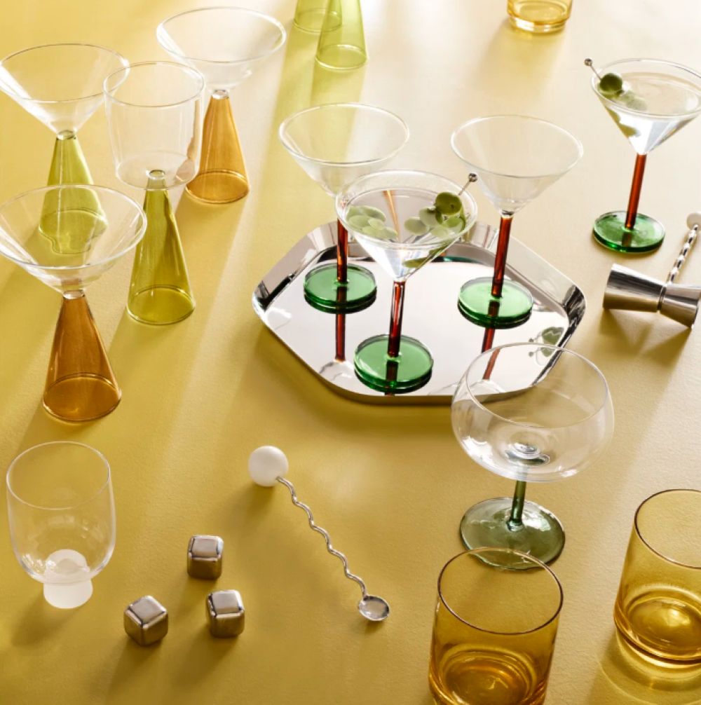 squiggle stirrer on yellow table among glassware
