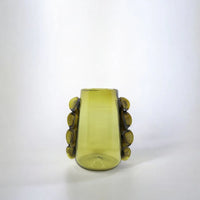 Green glass vase with decorative handles on a white background