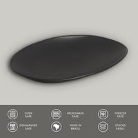 Black oval plate on a gray background with safety and feature icons at the bottom.