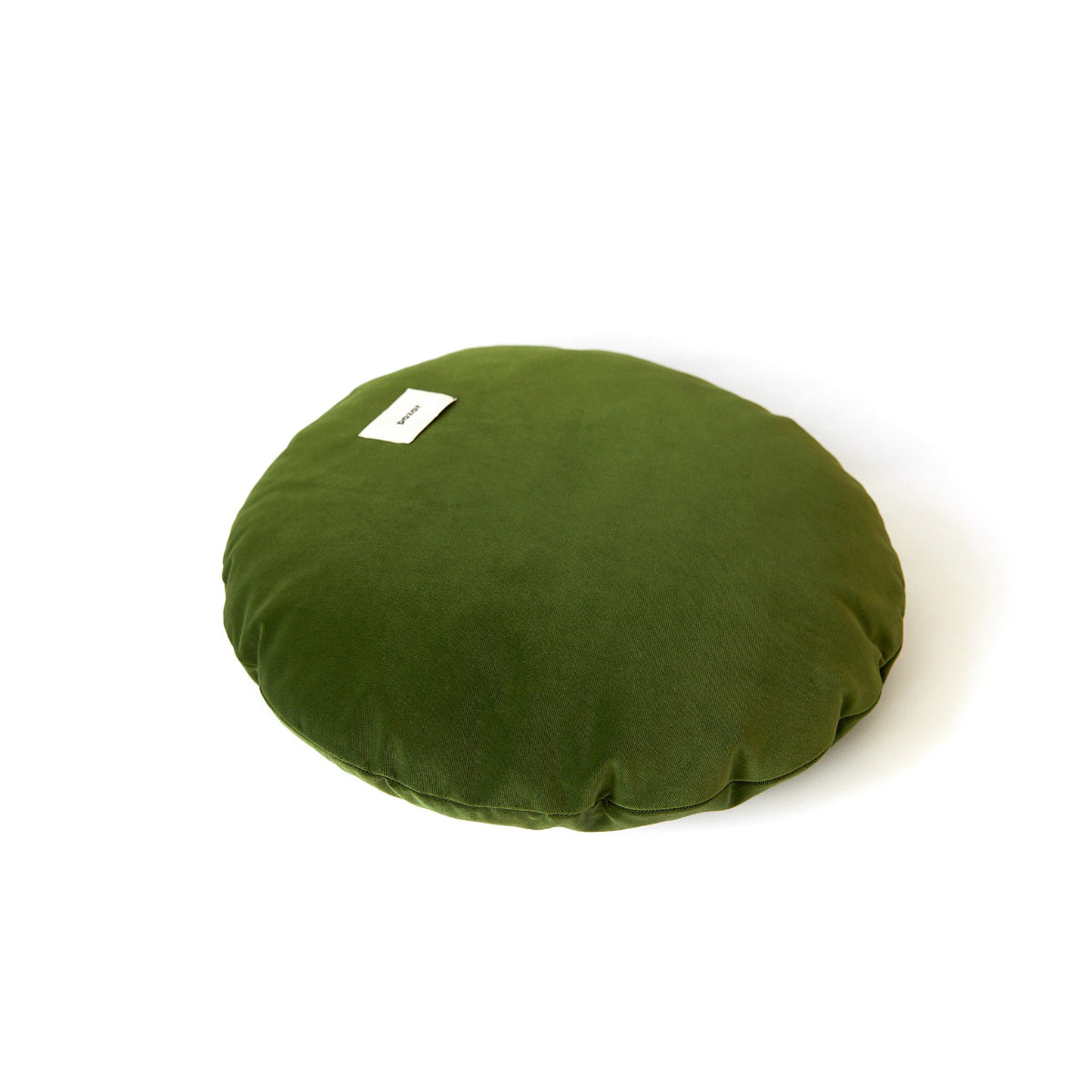 Green round cushion with a label on a white background