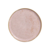 Round ceramic plate with a speckled pinkish-beige glaze on a white background