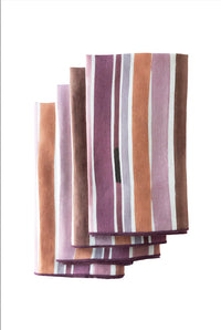 Stack of striped fabric napkins in purple, brown, and white on a white background