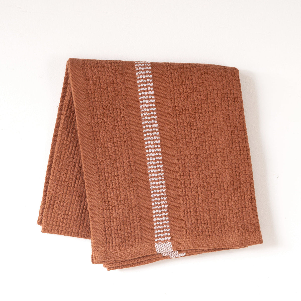 Rust color textured hand towel with a white stripe