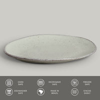 Round ceramic plate with speckled texture on a light gray background, featuring icons and text about safety and features.