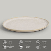 Round ceramic plate with textured surface on a gray background
