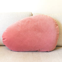 Pink velvet pillow on a beige couch