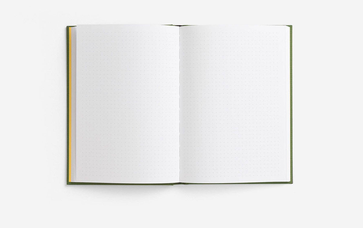 Open notebook with dotted pages on a white background