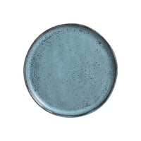 Blue ceramic plate with speckled texture on a white background