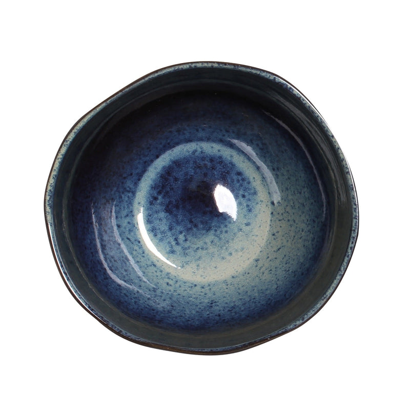 Ceramic bowl with blue speckled glaze on a white background