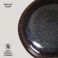 Ceramic plate with reactive glaze on a light gray background