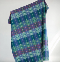 Plaid fabric with blue and green pattern on a white background