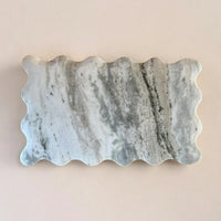 Marble-patterned stone with wavy edge on a beige background