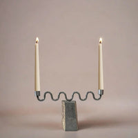 Candle holder with two candles on a neutral background