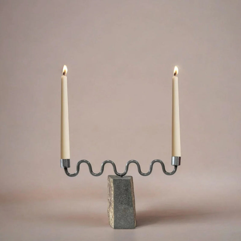 Candle holder with two candles on a neutral background