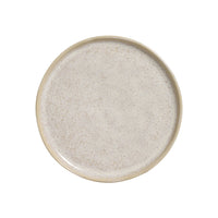Round ceramic plate with a textured surface on a white background