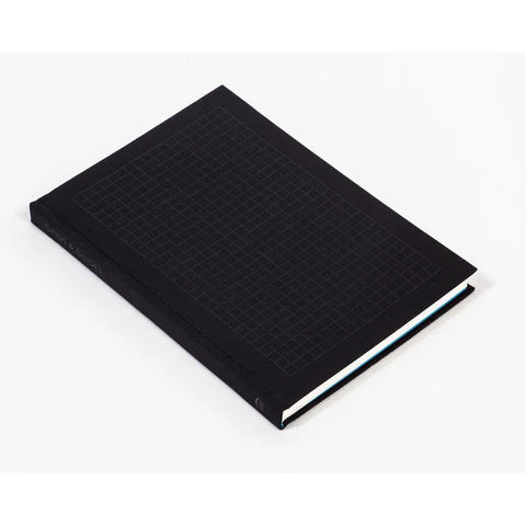 Black notebook with grid pattern cover on a white background