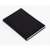 Black notebook with grid pattern cover on a white background