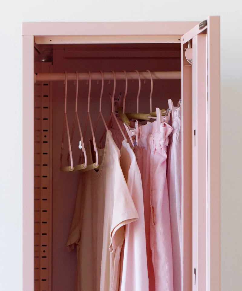Pink locker with clothes hanging on pink hangers