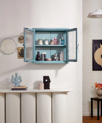 Blue wall cabinet with open doors displaying various items in a room setting.