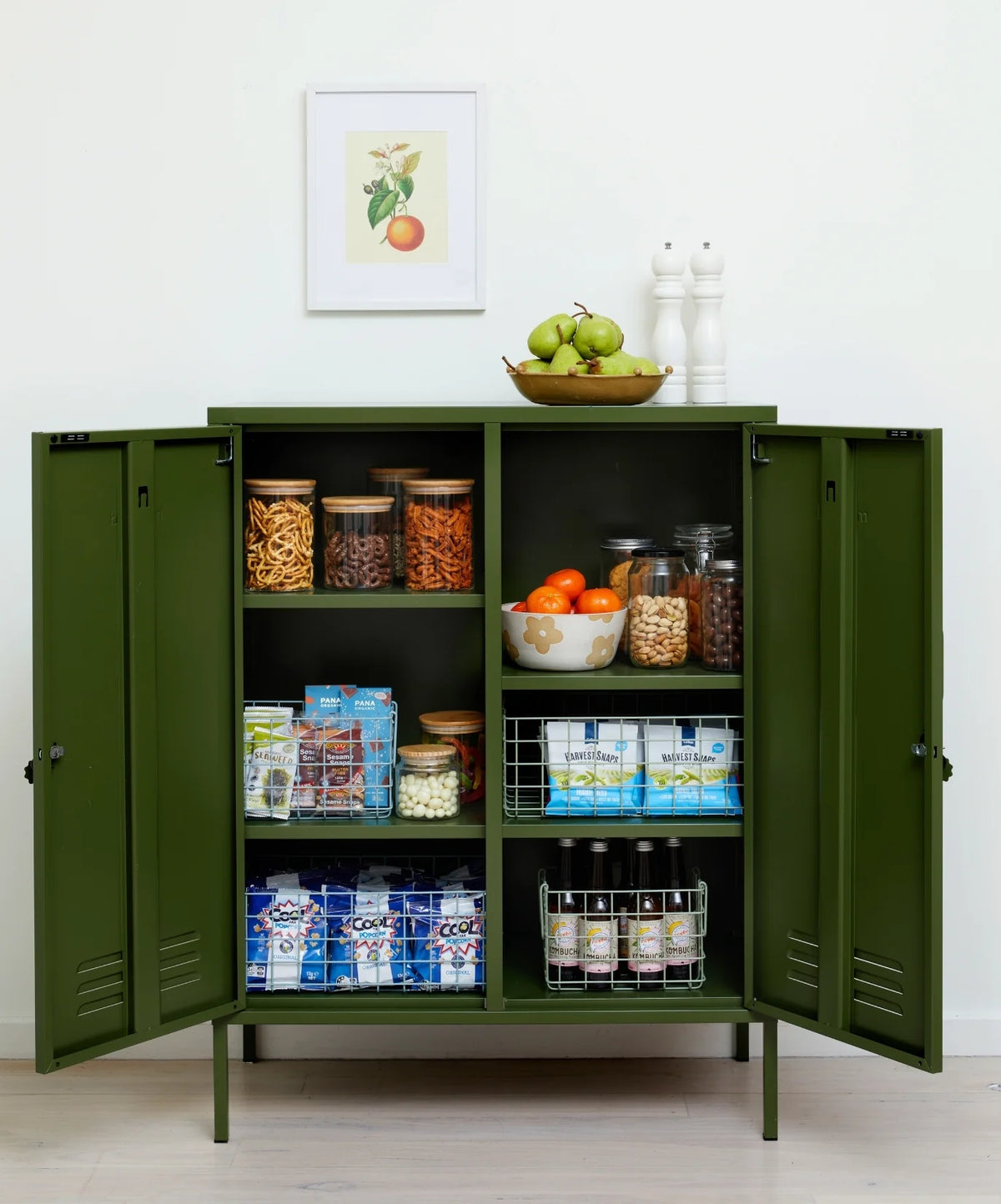 Green storage cabinet with food items on a white background