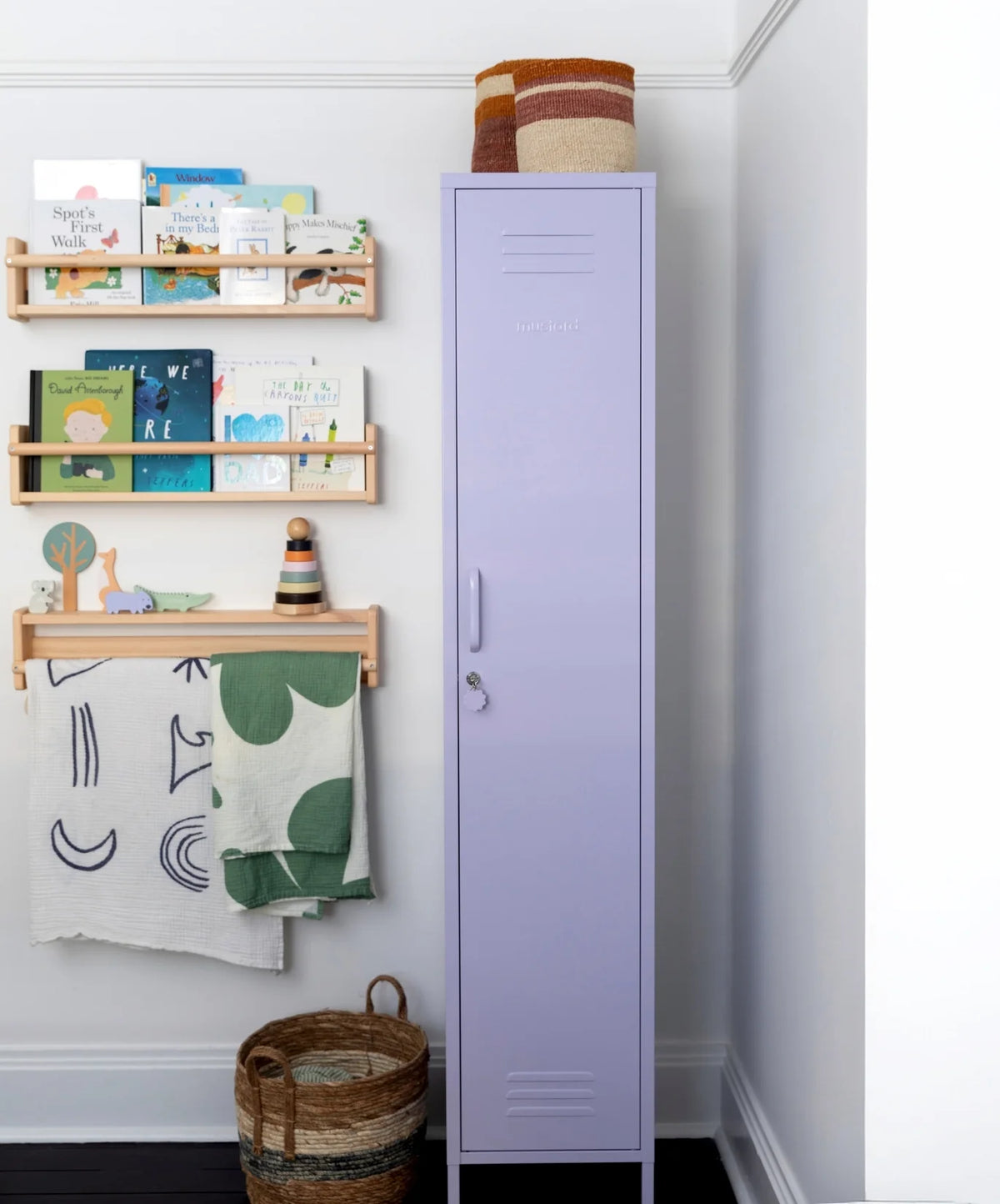 Purple locker with wooden shelves and decorative items against a white wall.