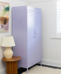 Purple locker in a room with a lamp and artwork on the wall.