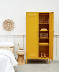 Yellow metal locker with open doors in a bedroom setting