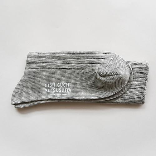 Gray socks with 'Nishiguchi Kutsushita' text on a light gray background