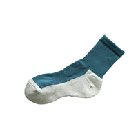 Teal and white ankle sock on a white background