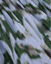 Close-up of a floral pattern with green, brown, and blue colors.