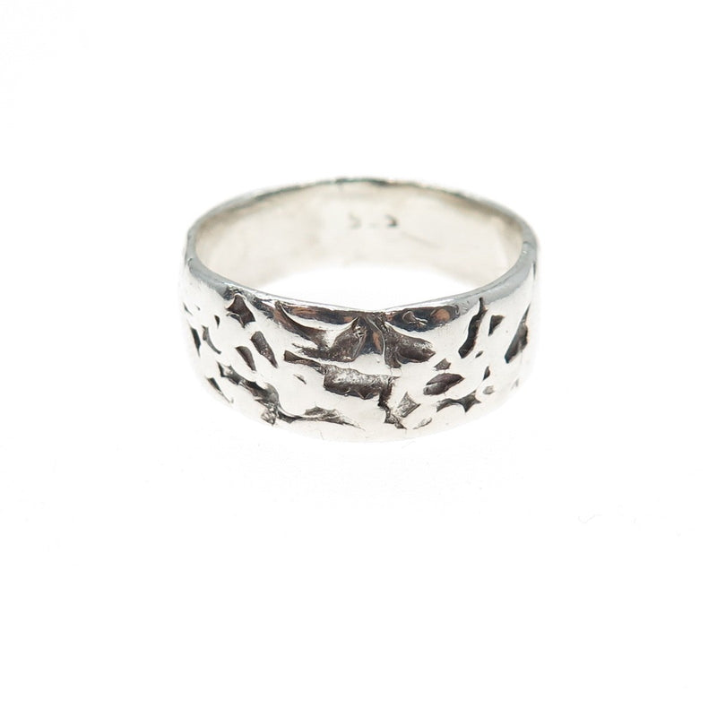 Silver textured band ring on a white background