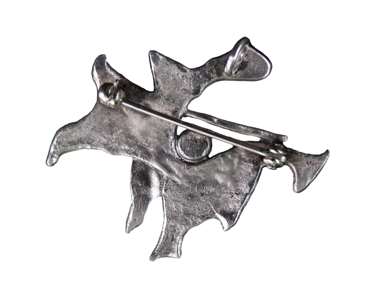 back of a silver brooch/pendant on a white background
