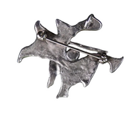 back of a silver brooch/pendant on a white background