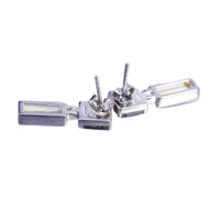 Backside of a pair of silver earrings on a white background