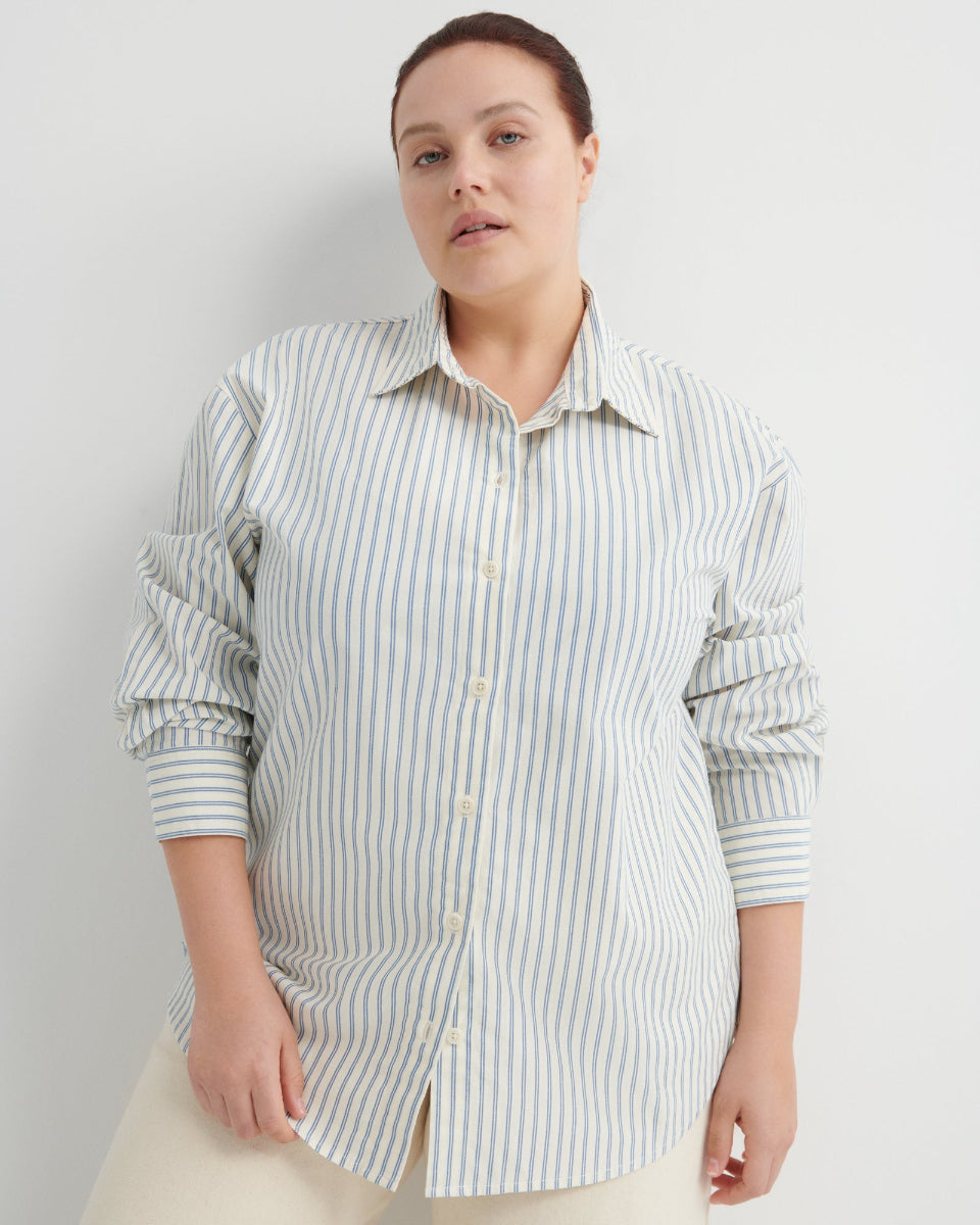 Woman wearing a striped shirt against a plain background