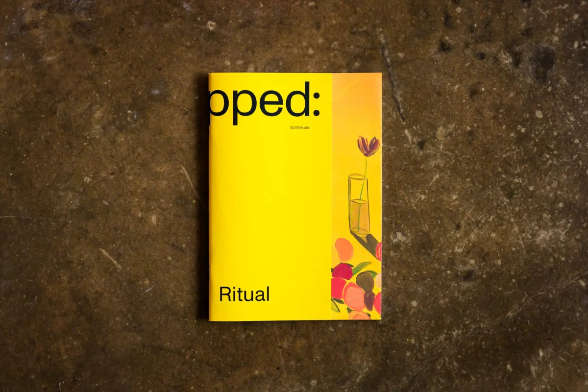 Yellow magazine titled 'Ritual' on a textured brown surface