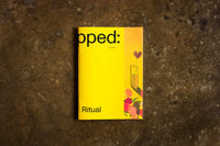 Yellow magazine titled 'Ritual' on a textured brown surface